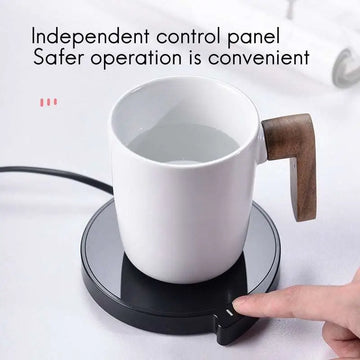 White ceramic smart coffee mug with wooden handle on black coffee mug warmer with three temperature settings