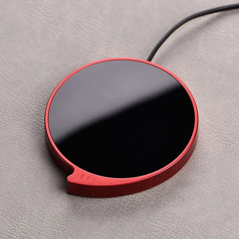 Red circular smart coffee mug warmer with glossy black center metallic red frame and three temperature settings