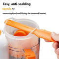 Orange plastic spatula with ergonomic handle used for baby food preparation in smart multi-function baby food processor