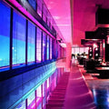 A sleek modern staircase illuminated by smart wi-fi connectivity colorful led lights strip in vibrant pink and blue neon