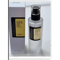 Clear glass bottle with black pump and gold label containing transparent liquid for snail revive moisturizer cleansing gel
