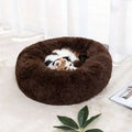 Plush brown circular cat bed with soft fluffy texture designed as a warm pet bed for winter comfort