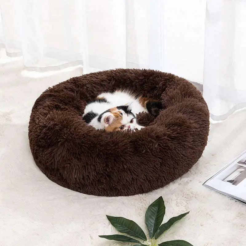 Plush brown circular cat bed with soft fluffy texture designed as a warm pet bed for winter comfort
