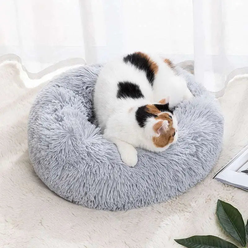 A cozy gray circular warm pet bed with a soft fluffy texture and plush winter warm material for pets