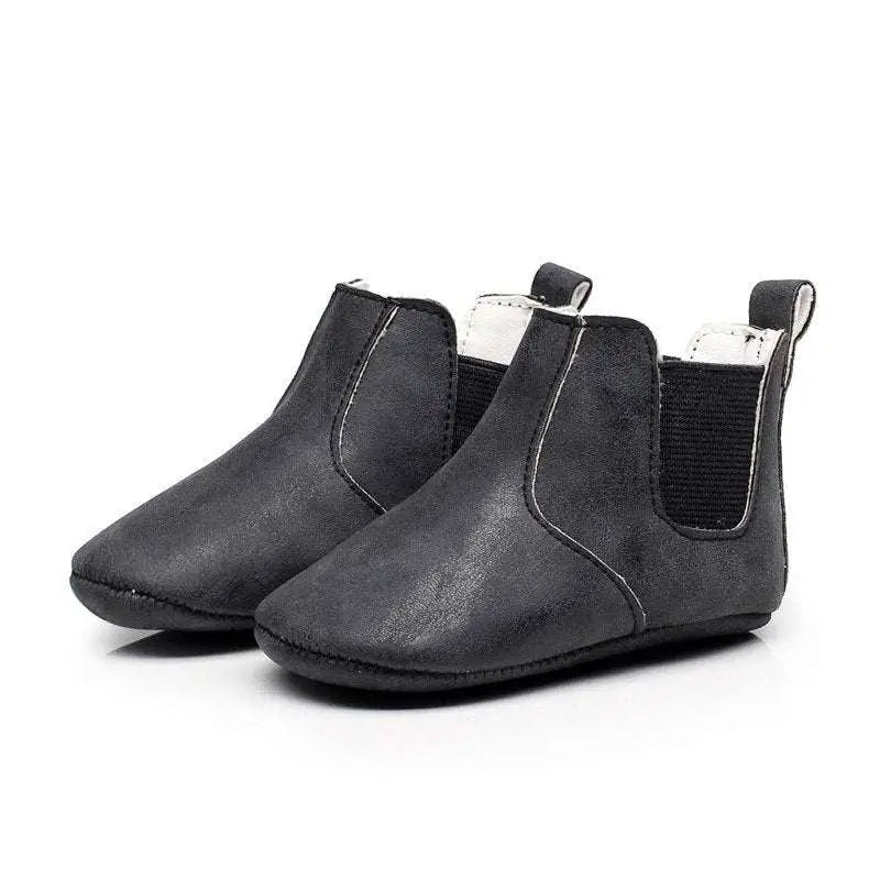 Black soft suede baby shoes with white lining and elastic side panels toddler booties for easy wear