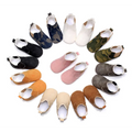 A collection of soft suede baby toddler booties in solid colors and camouflage patterns for infants and toddlers