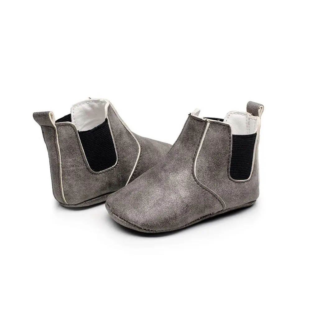A collection of soft suede baby toddler booties in solid colors and camouflage patterns for infants and toddlers