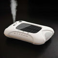 White solar car air purifier with sleek rounded design gold trim and green led indicators for vehicle use