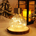 A clear crackle glass small night light with warm white led and brushed metal solar cap ambient light