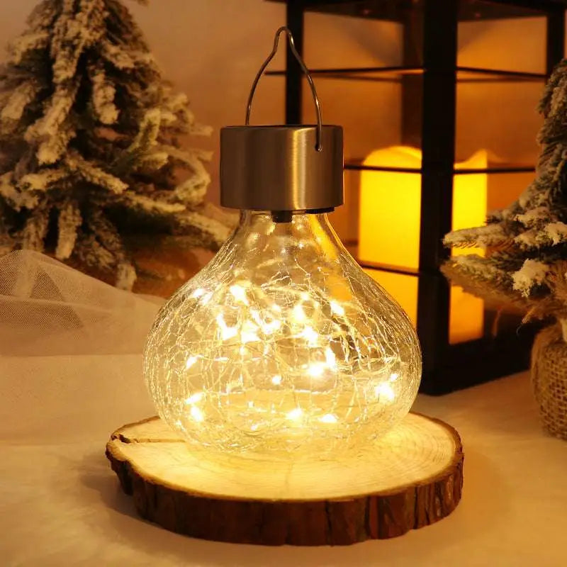 A clear crackle glass small night light with warm white led and brushed metal solar cap ambient light