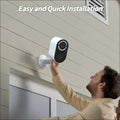 White and black solar powered wireless security camera with sleek modern design mounted on a wall for outdoor use
