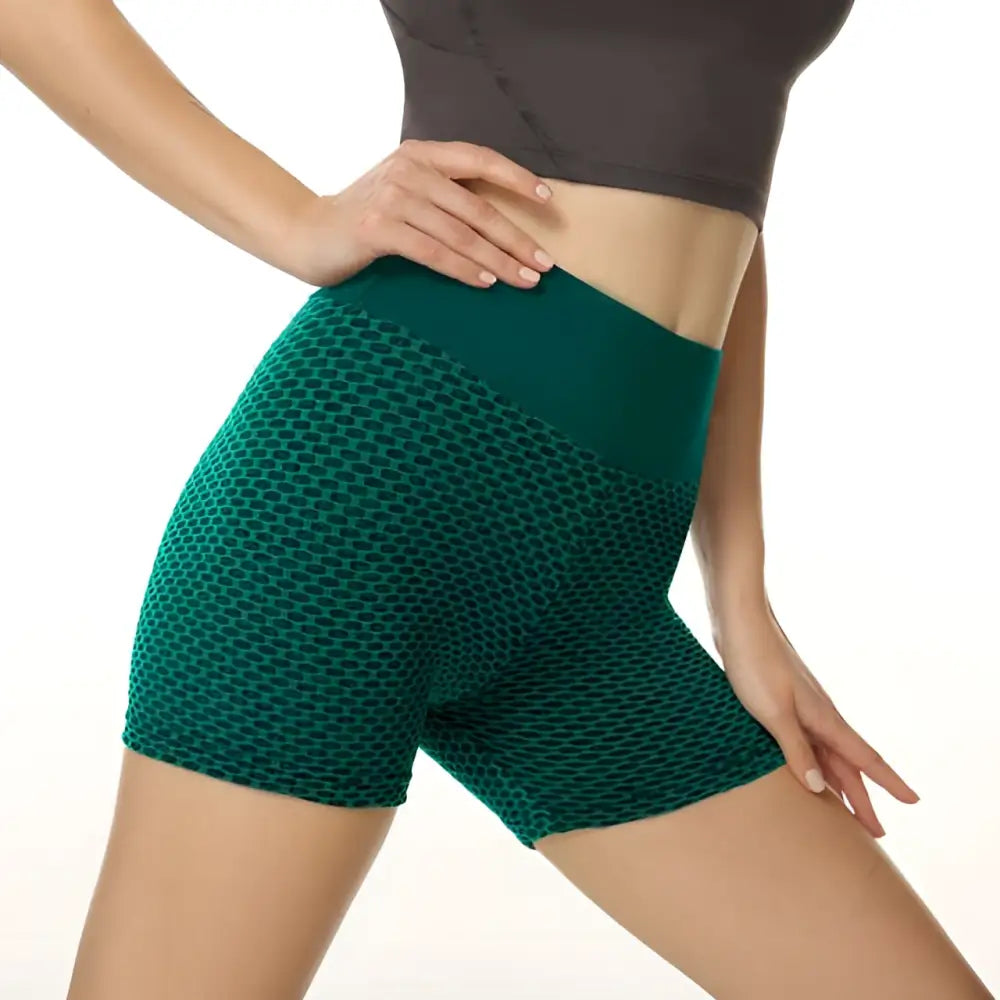 Emerald green high-waisted solid color yoga shorts with textured honeycomb design and matching waistband