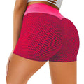 Bright pink high-waisted solid color honeycomb design yoga shorts with textured mesh pattern and solid waistband