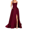 A flowing deep burgundy satin evening gown with a square neckline and thin spaghetti straps in purple satin