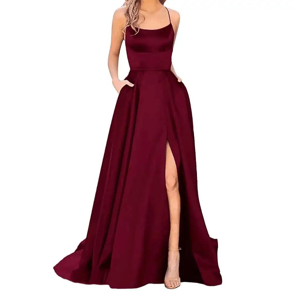 A flowing deep burgundy satin evening gown with a square neckline and thin spaghetti straps in purple satin