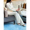 White leather handbag with gold-tone hardware paired with a solid color single-breasted blazer and pants set