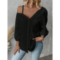 Black off-the-shoulder blouse with sheer textured fabric and puffed sleeves contrasting white asymmetric blouse features