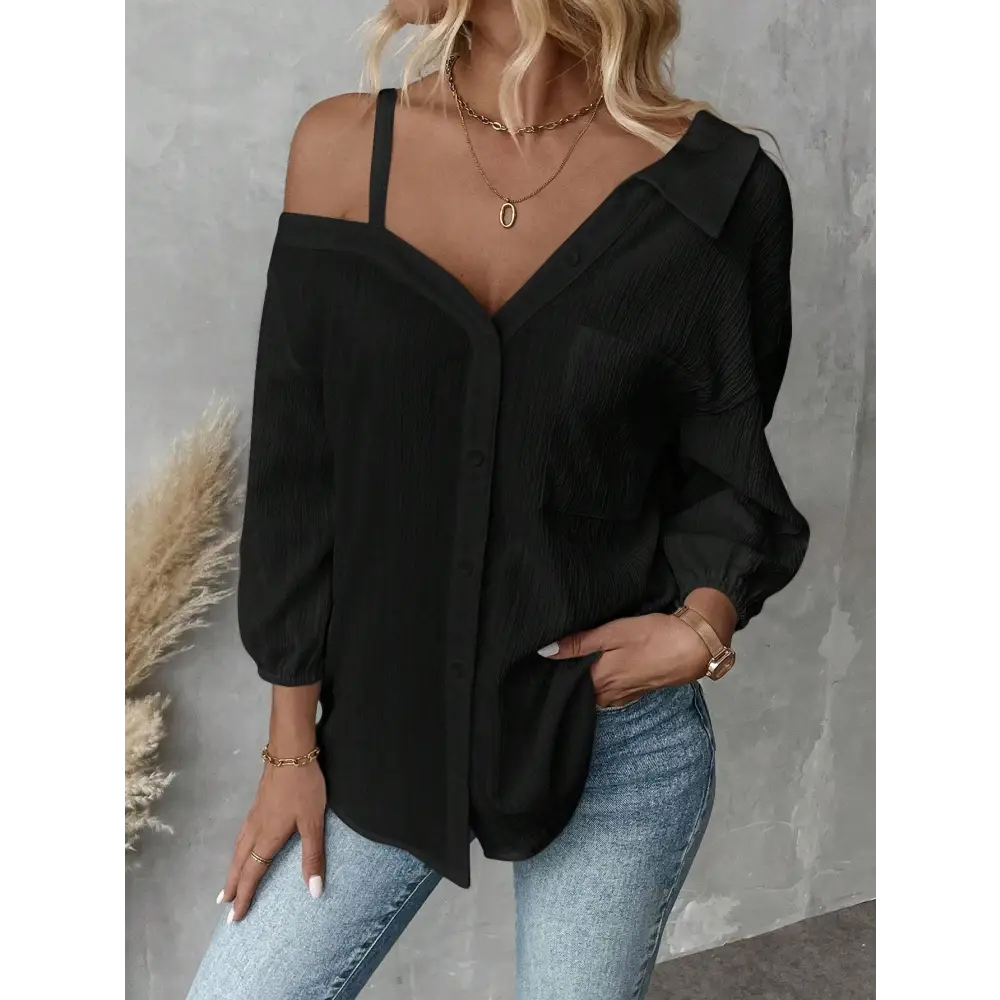 Black off-the-shoulder blouse with sheer textured fabric and puffed sleeves contrasting white asymmetric blouse features