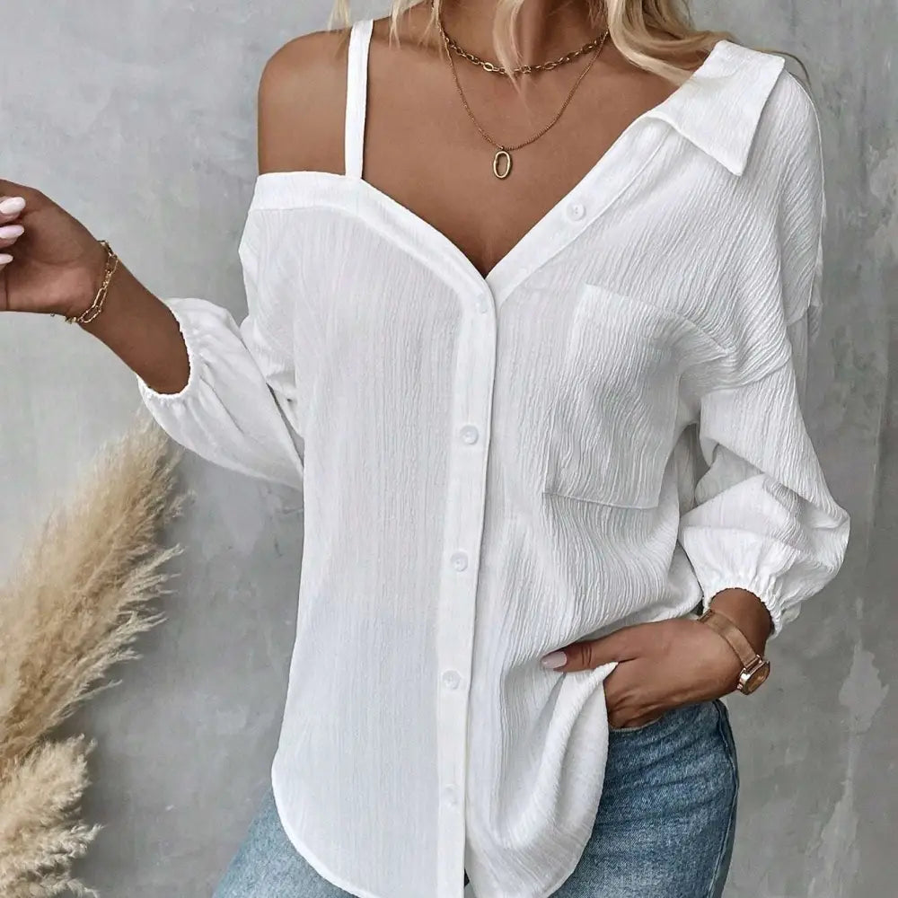 White asymmetric blouse featuring sheer textured fabric in a relaxed off shoulder button down style