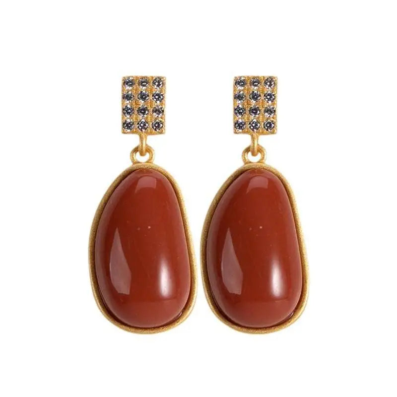 Gold-toned southern red agate lucky bean drop earrings with rectangular pave tops and reddish-brown teardrop cabochons