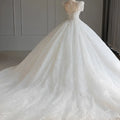Sparkling beaded white wedding dress with voluminous tail showing intricate beading on the back for white trailing wedding events