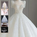 A sparkling beaded white wedding dress with off-the-shoulder sleeves and a voluminous tail, ideal as a floral wedding dress