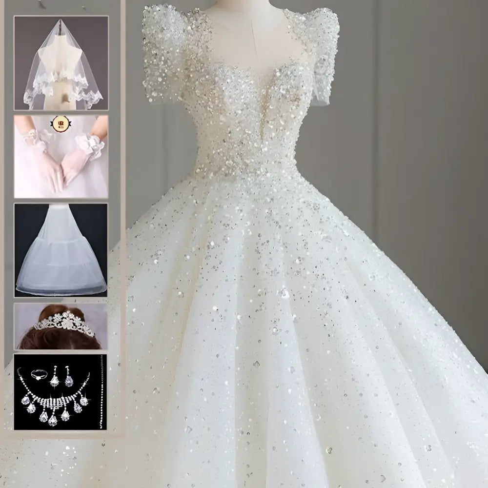 A sparkling beaded white wedding dress with off-the-shoulder sleeves and a voluminous tail, ideal as a floral wedding dress
