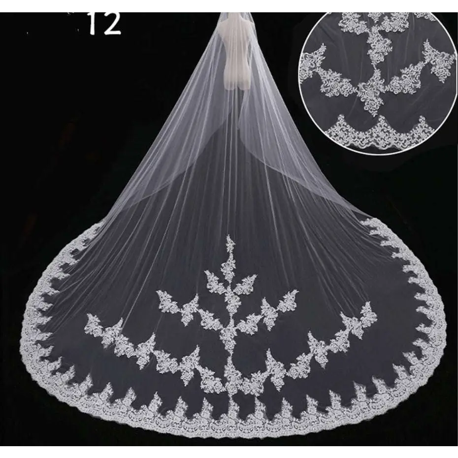 A delicate white bridal wedding dress veil with intricate floral embroidery and flowing sheer fabric for weddings