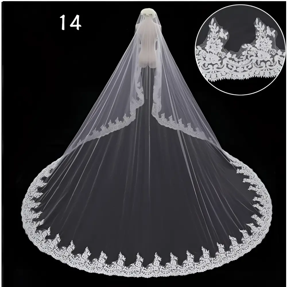 A delicate white lace wedding dress veil with intricate floral embroidery displayed on a mannequin for bridal wedding dress use