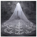 A delicate white lace wedding dress veil with intricate floral embroidery for a sparkling wide style bridal wedding dress