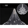 A delicate white bridal wedding dress veil with intricate floral embroidery and a decorative central motif