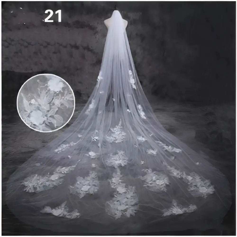 A delicate white lace bridal wedding dress veil with intricate floral embroidery and a flowing sheer design