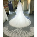 Sparkling wide style bridal wedding dress veil featuring a long white flowing veil with intricate floral lace detailing