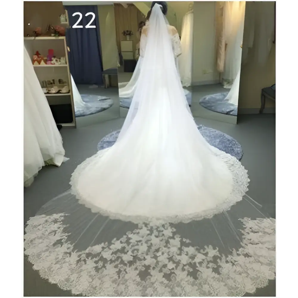 Sparkling wide style bridal wedding dress veil featuring a long white flowing veil with intricate floral lace detailing