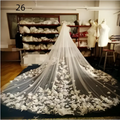 A long flowing white lace bridal wedding dress veil with intricate floral embroidery and delicate beading