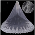 A long white sparkling wide style bridal wedding dress veil with intricate floral embroidery and lace detailing