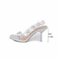 Square toe rhinestone sandals with clear plastic transparent strap and silver floral embellishments on metallic heel