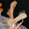 Square toe rhinestone transparent high-heeled mules with silver floral embellishments and metallic gold insole
