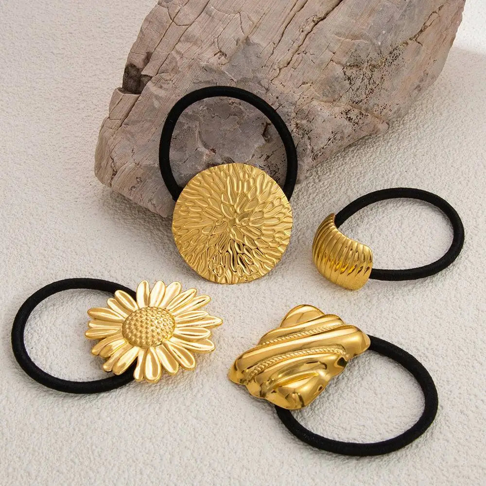Gold-toned stainless steel flower elastic hair ties with intricate floral and abstract designs on black bands