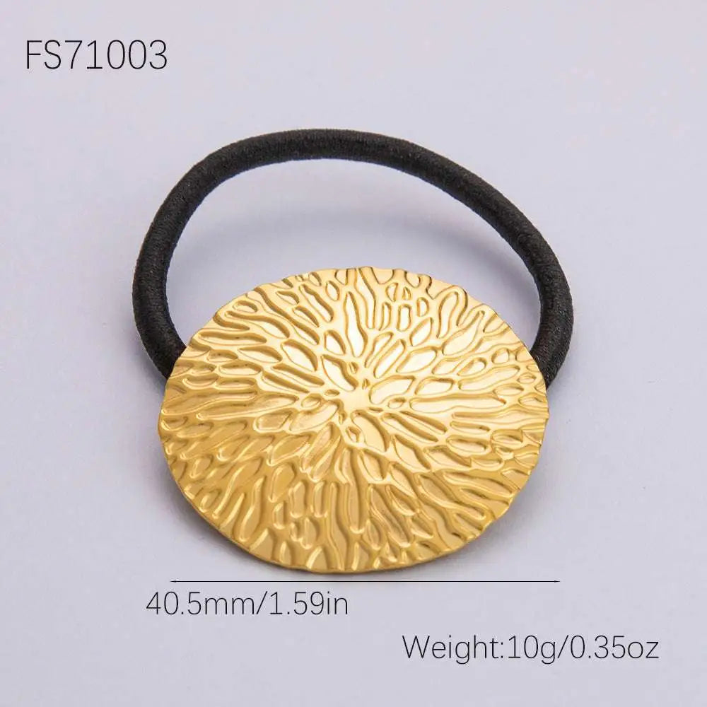 Gold-toned stainless steel flower elastic hair tie with embossed leaf pattern and black elastic band for secure hold