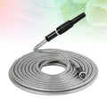 Silver stainless steel metal garden hose coiled with black spray nozzle and connector for outdoor watering tasks