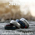 Black and silver stainless steel odin norse rune ring with blue inlay displayed on a textured surface for men’s fashion