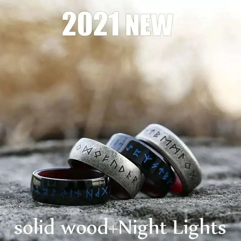 Black and silver stainless steel odin norse rune ring with blue inlay displayed on a textured surface for men’s fashion