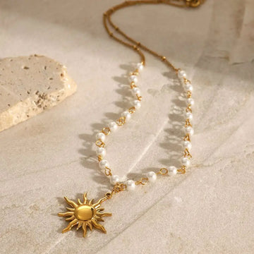 Stainless steel pearl necklace featuring a gold sun pendant with small white pearls for elegant wear