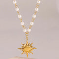 Stainless steel pearl necklace featuring a gold sun pendant with a chain of alternating small white pearls and gold links