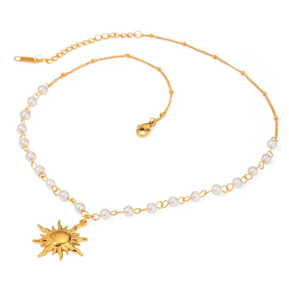 Stainless steel pearl necklace featuring a gold sun pendant with small white pearls on a delicate chain