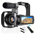 Standard black digital camcorder dv06s with silver lens ring, hooded design, mounted microphone, and flip-out screen showing architecture