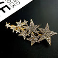 A sparkling gold star diamond barrettes adorned with numerous clear rhinestones featuring small pentagrams head styling