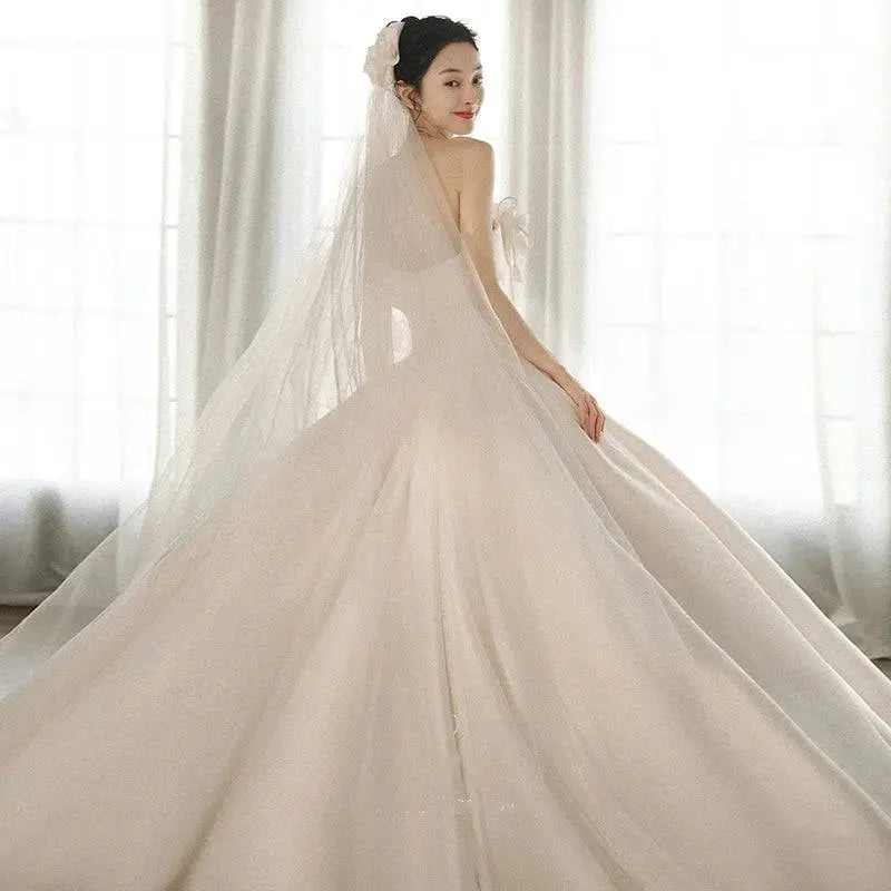 Strapless ivory wedding gown with fitted bodice and expansive layered skirt in luxury women’s fashion