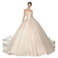 Strapless ivory satin ball gown with fitted bodice embroidered floral appliqué and voluminous glittering skirt luxury women’s fashion